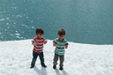 Boys on snow, turquoise lake, Styrn, Norway.